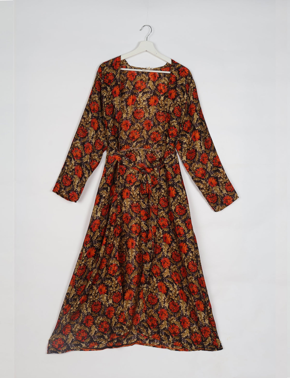 Brown floral beach robe with long sleeves and waist tie, hanging on white hanger against white background