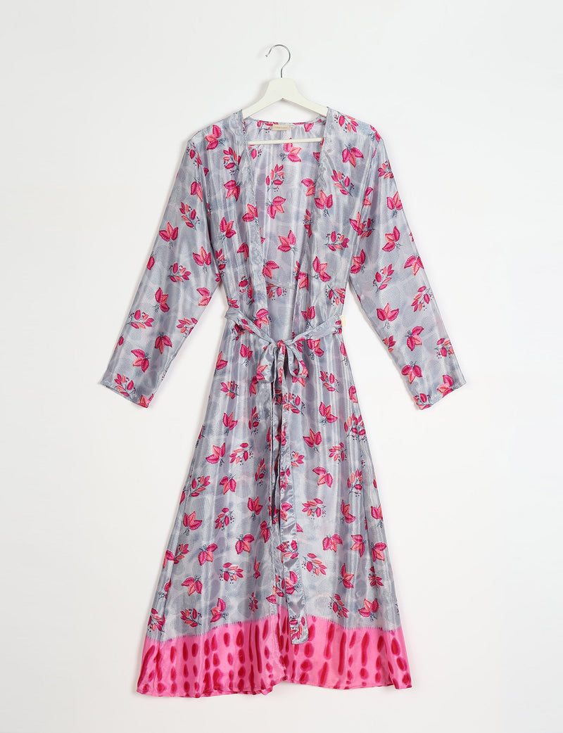 Long-sleeve beach robe with pink leaf print on gray background and bright pink patterned hem, hanging on white hanger
