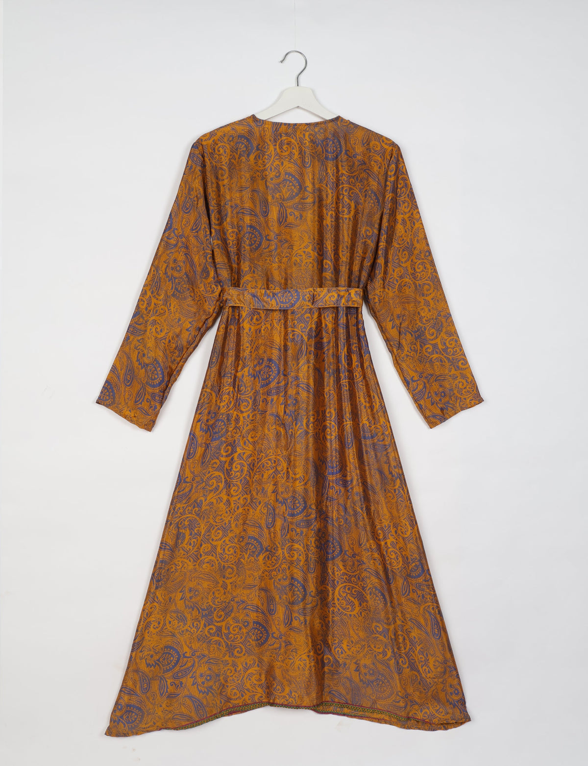 Yellow and purple paisley patterned long-sleeve beach robe with belt, shown from back on white hanger against white