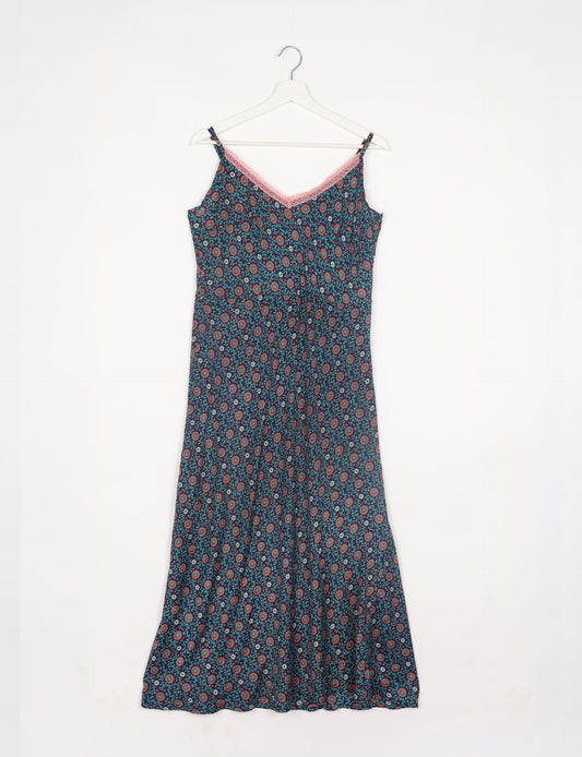 Spaghetti strap dress made from sustainable materials, embodying ethical fashion principles. Ideal for eco-friendly travelers seeking laid-back style.