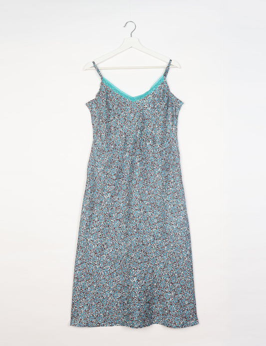 Spaghetti strap dress made from sustainable materials, embodying ethical fashion principles. Ideal for eco-friendly travelers seeking laid-back style.
