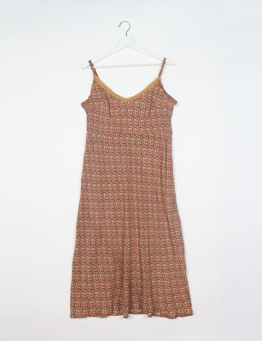Spaghetti strap dress made from sustainable materials, embodying ethical fashion principles. Ideal for eco-friendly travelers seeking laid-back style.