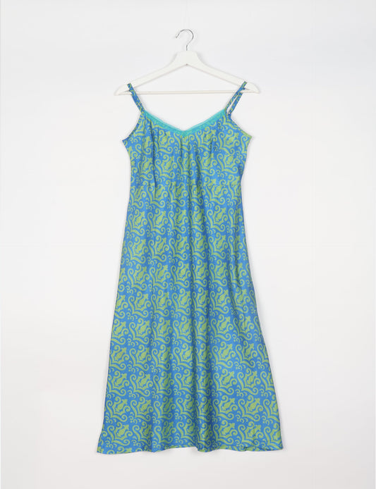 Spaghetti strap dress made from sustainable materials, embodying ethical fashion principles. Ideal for eco-friendly travelers seeking laid-back style.