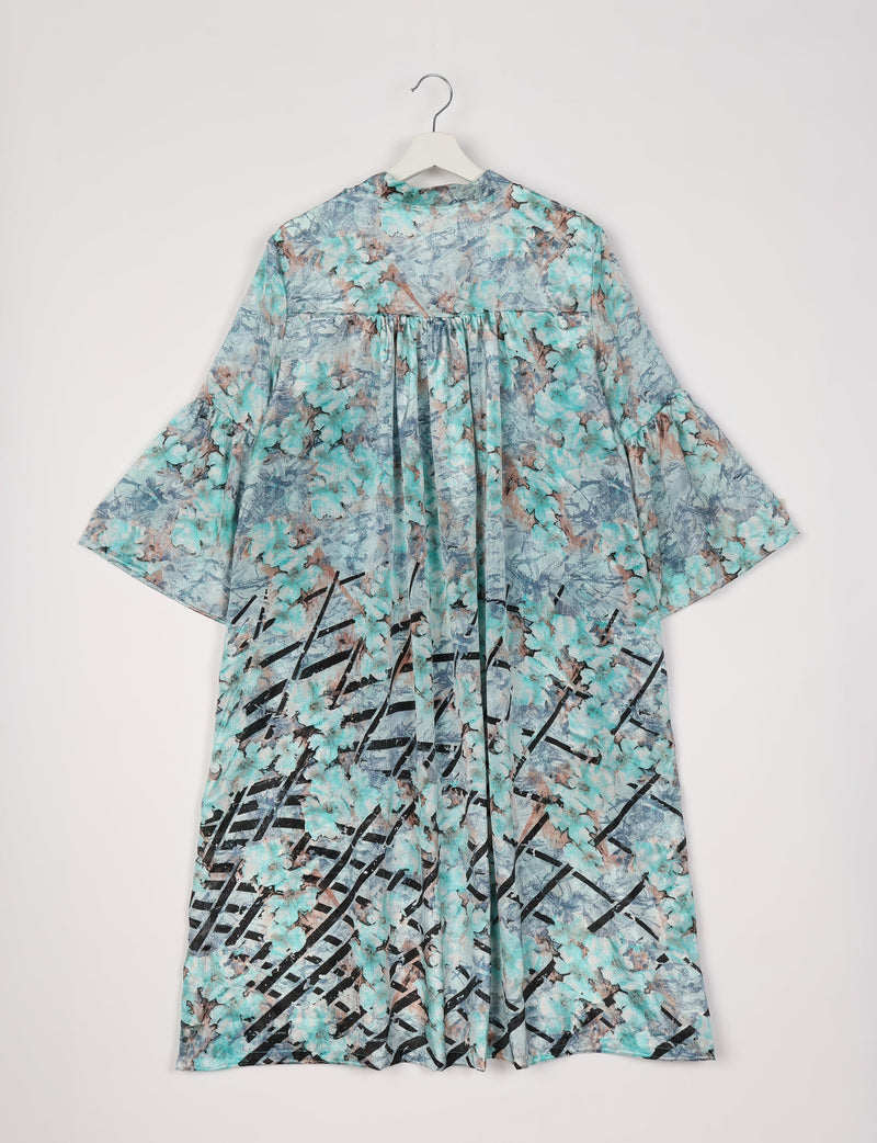 Blue floral bell sleeve coat with gathered back yoke and abstract black line pattern, hanging on white hanger