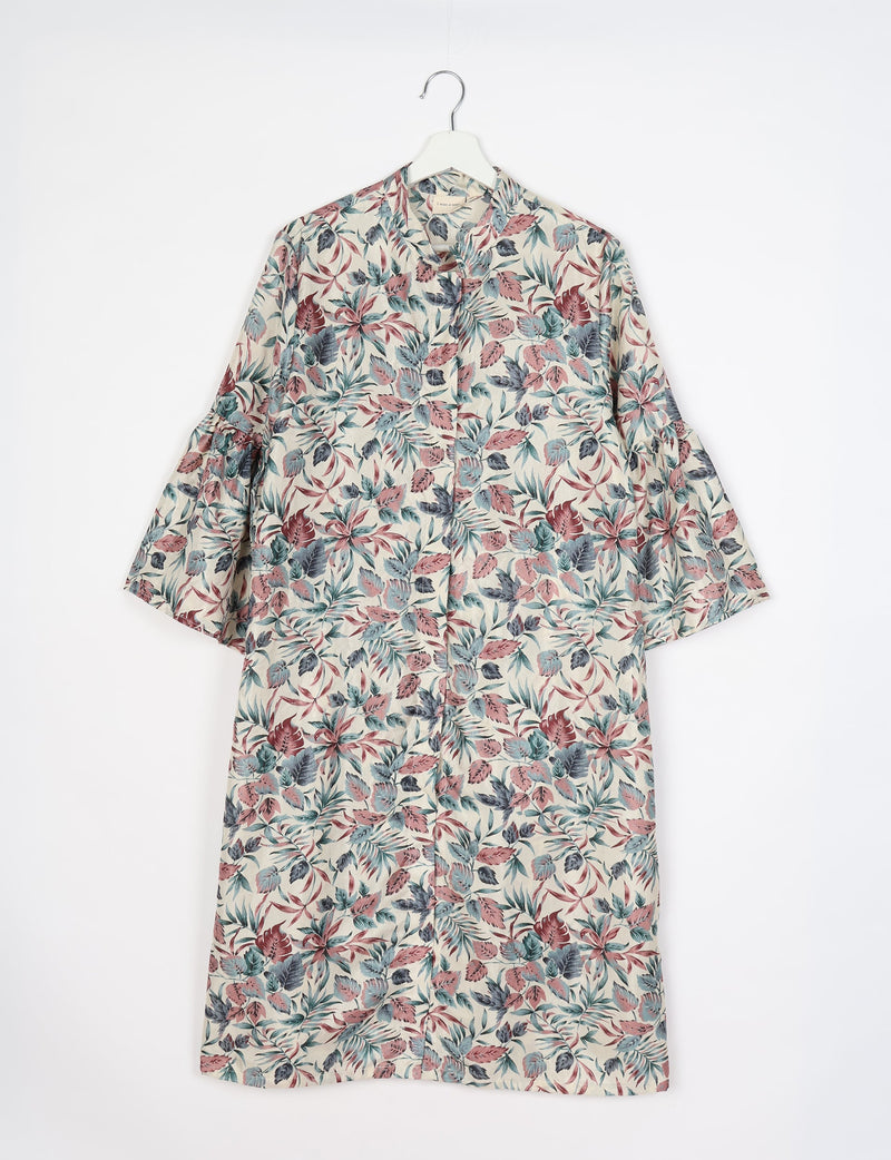 White bell sleeve coat with multicolor leaf print, front button closure, and a mandarin collar, hanging on white hanger