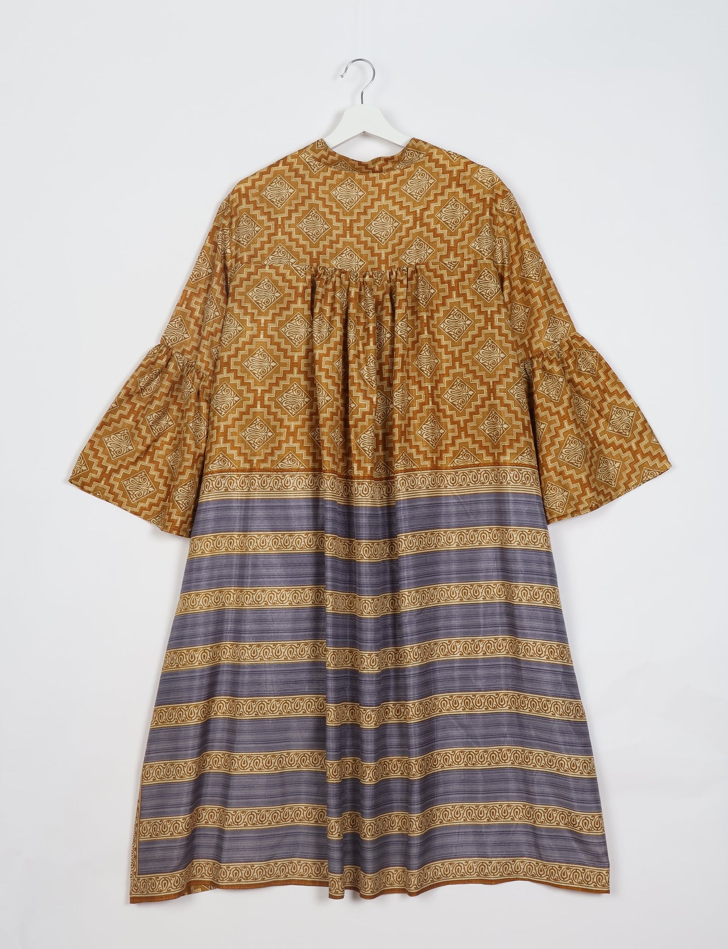 Discover ethical elegance with our Bell Sleeve Coat, handcrafted by Indian artisans from recycled materials. This sustainable fashion piece is a statement in eco-friendly clothing, combining style and consciousness effortlessly.