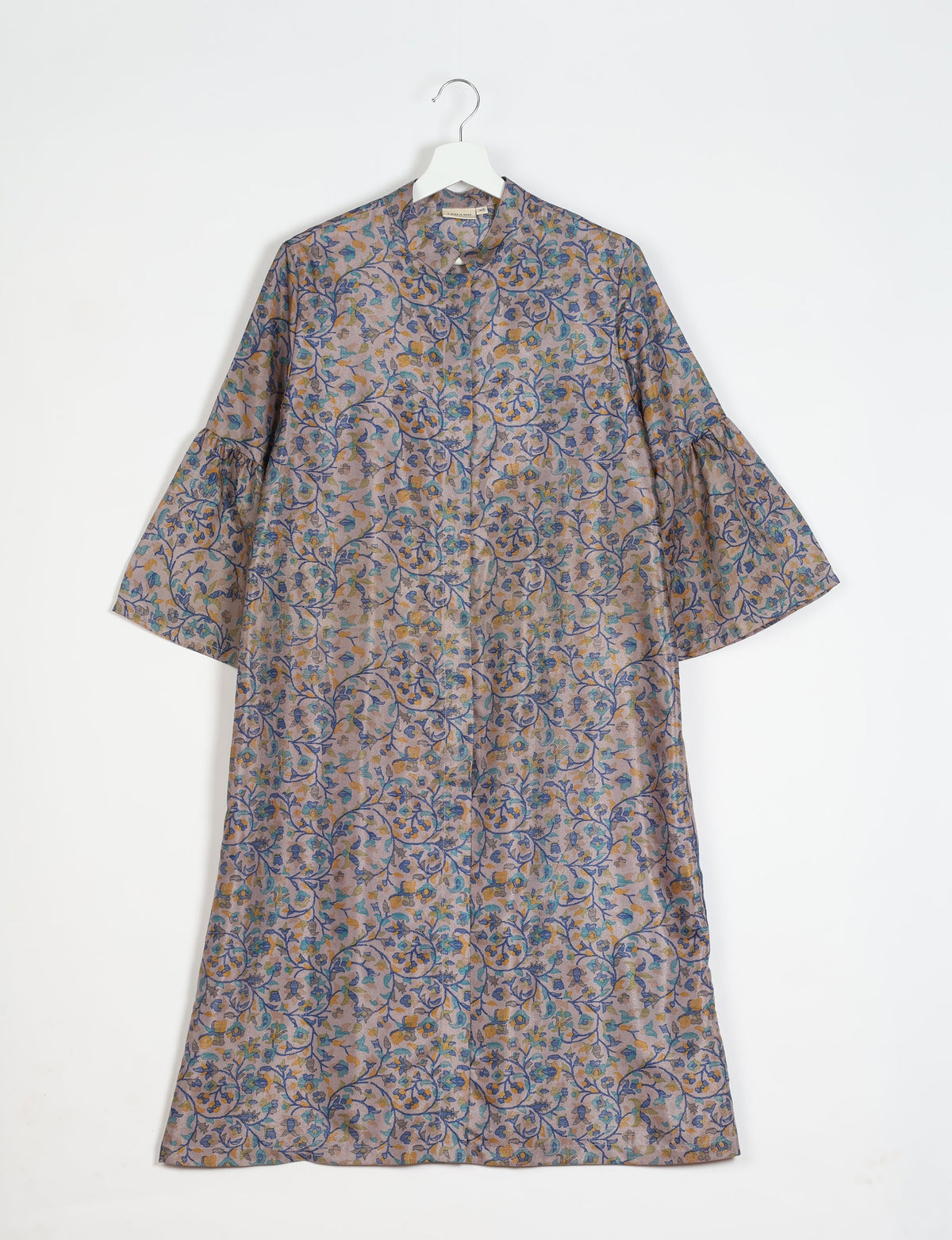 Grey bell sleeve coat with blue and yellow floral tropical print, front button closure, hanging on white hanger