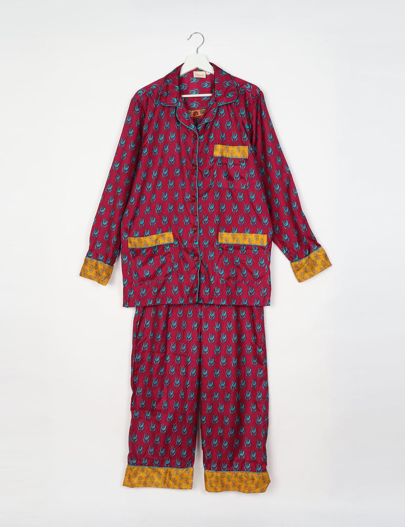 Long-sleeve button-up pajama set in burgundy with blue floral print and contrasting yellow cuffs and pocket trims, hanging flat