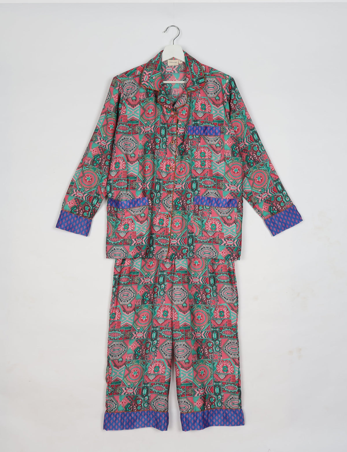 Pink Indian ethnic long-sleeve pajama set with geometric and floral patterns and contrasting blue cuffs and pocket trim