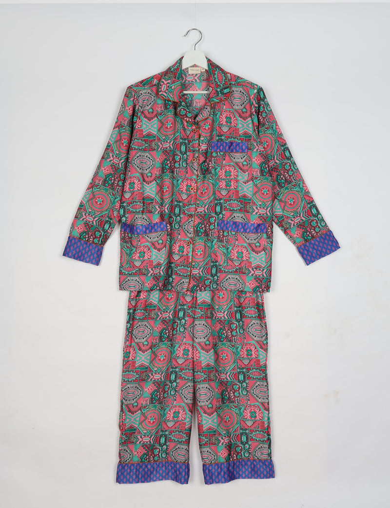 Pink Indian ethnic long-sleeve pajama set with geometric and floral patterns and contrasting blue cuffs and pocket trim