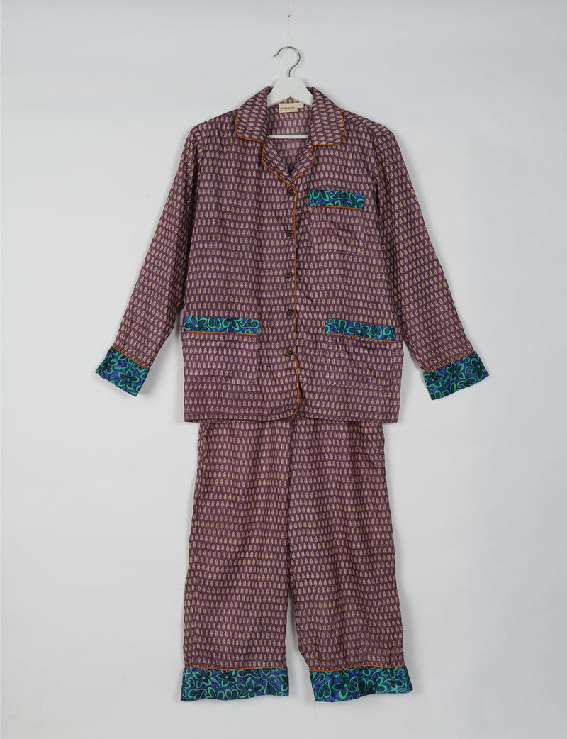 Purple pajama set with long sleeves and pants, featuring small beige leaf patterns and blue floral trim on cuffs and pockets