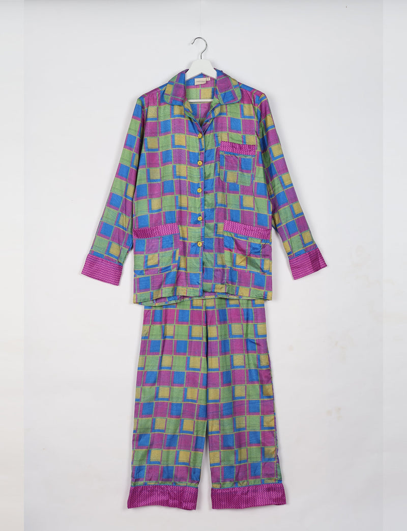 Long-sleeve pajama set in pink geometric pattern with button front and contrasting cuffs, hanging on white hanger