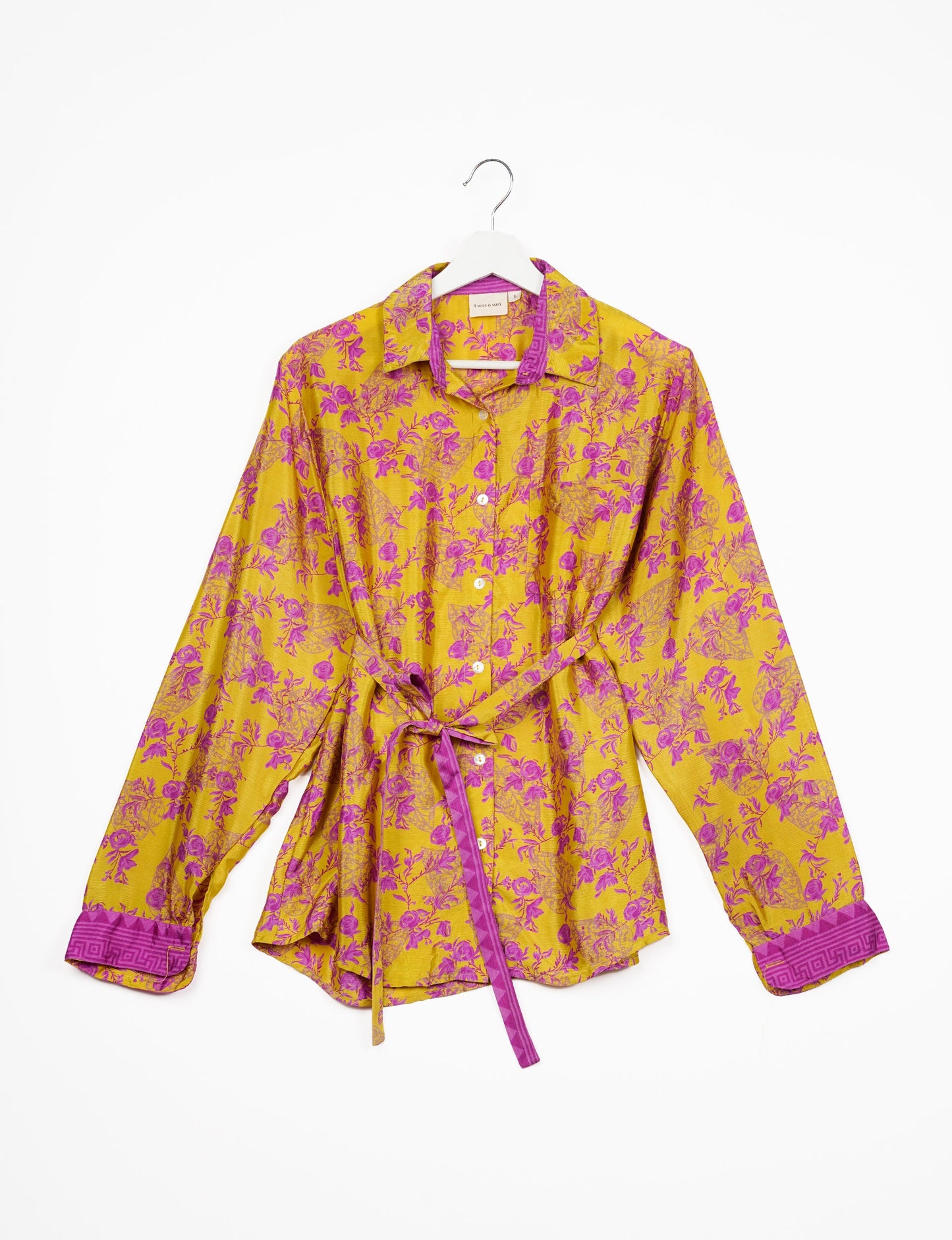 Experience sustainable fashion with our classic slim-fit shirt, crafted with ethical and green values. The shirt, designed for minimal waste, features a tie-up waist belt or neck tie, semi-spread collar, and regular shirt cuffs. Versatile and eco-friendly, wear it tucked in, unbuttoned over a tank top, or knotted at the waist for a unique style.