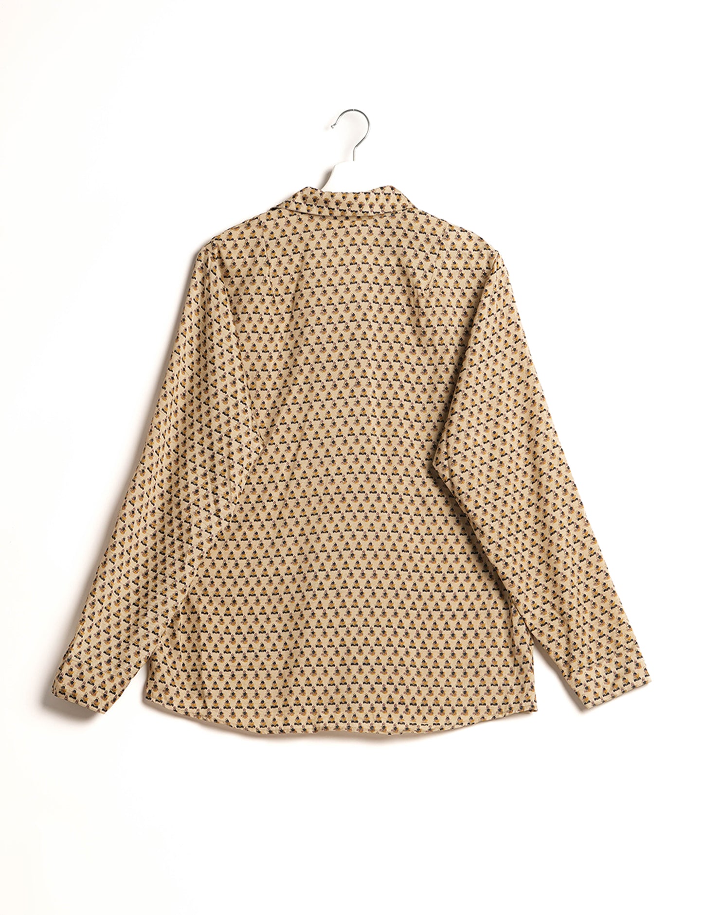 Experience sustainable fashion with our classic slim-fit shirt, crafted with ethical and green values. The shirt, designed for minimal waste, features a tie-up waist belt or neck tie, semi-spread collar, and regular shirt cuffs. Versatile and eco-friendly, wear it tucked in, unbuttoned over a tank top, or knotted at the waist for a unique style.