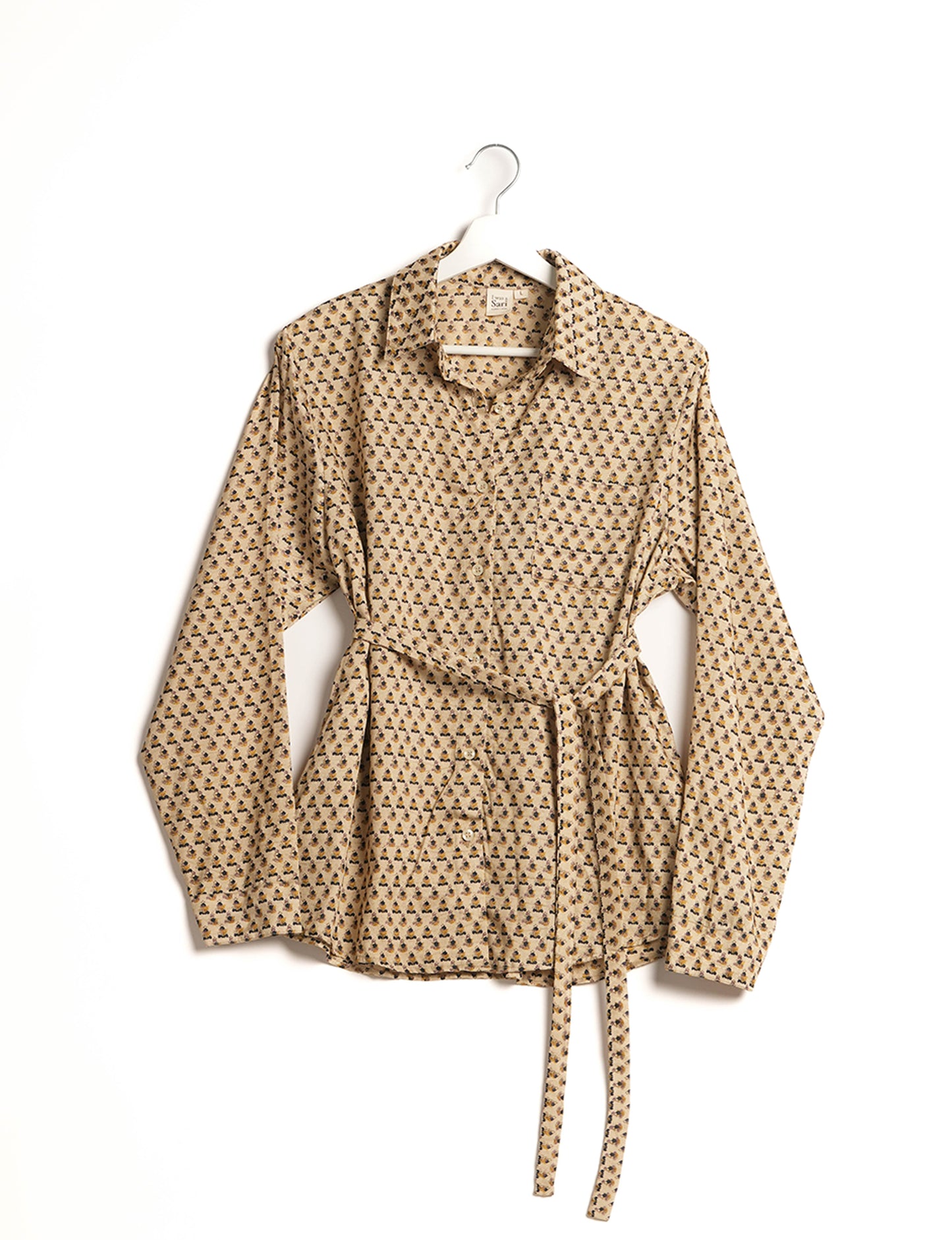 Experience sustainable fashion with our classic slim-fit shirt, crafted with ethical and green values. The shirt, designed for minimal waste, features a tie-up waist belt or neck tie, semi-spread collar, and regular shirt cuffs. Versatile and eco-friendly, wear it tucked in, unbuttoned over a tank top, or knotted at the waist for a unique style.