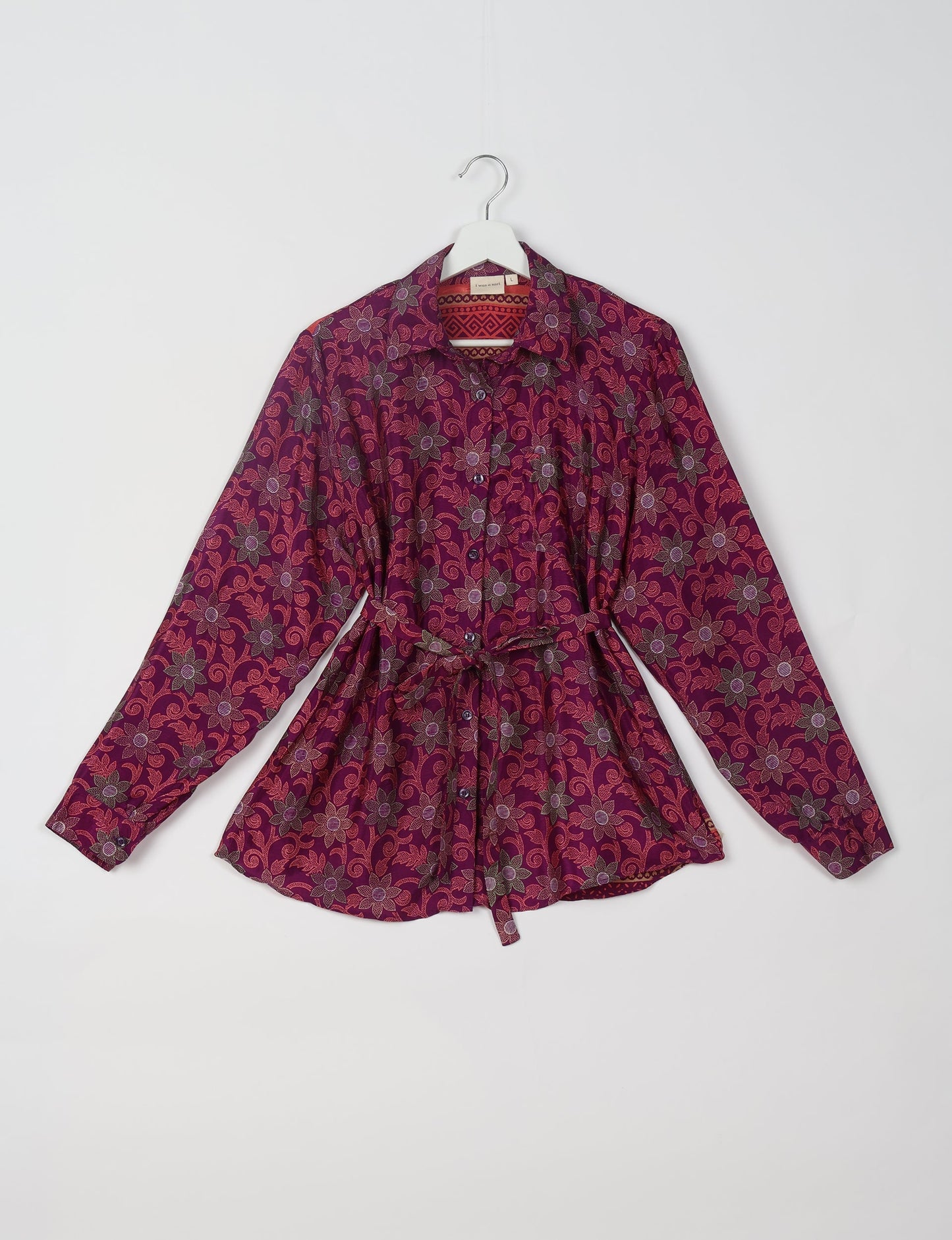 Experience sustainable fashion with our classic slim-fit shirt, crafted with ethical and green values. The shirt, designed for minimal waste, features a tie-up waist belt or neck tie, semi-spread collar, and regular shirt cuffs. Versatile and eco-friendly, wear it tucked in, unbuttoned over a tank top, or knotted at the waist for a unique style.