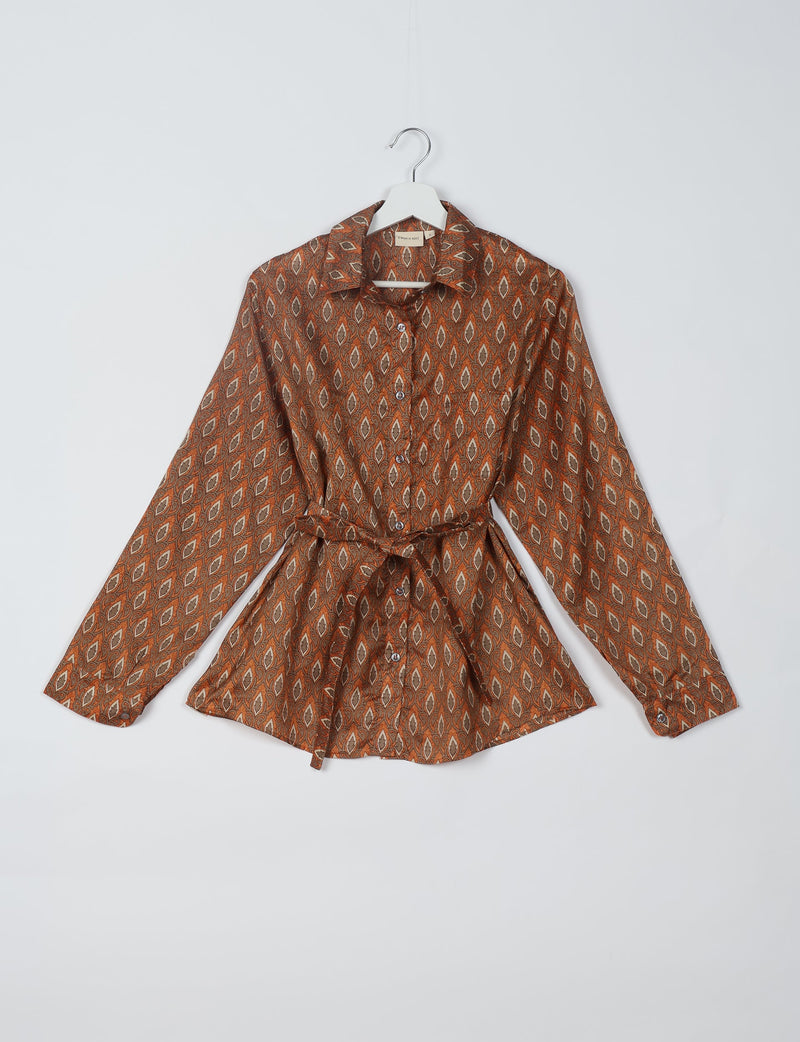 Long-sleeve button-up shirt with brown and beige leaf pattern, collar, and waist tie, displayed on white hanger