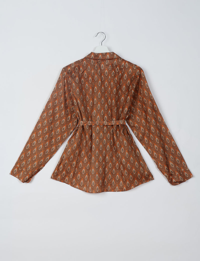 Long-sleeve shirt with brown and beige leaf pattern, back view, hanging on white hanger against white background