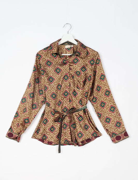 Experience sustainable fashion with our classic slim-fit shirt, crafted with ethical and green values. The shirt, designed for minimal waste, features a tie-up waist belt or neck tie, semi-spread collar, and regular shirt cuffs. Versatile and eco-friendly, wear it tucked in, unbuttoned over a tank top, or knotted at the waist for a unique style.