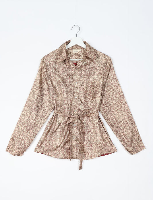 Experience sustainable fashion with our classic slim-fit shirt, crafted with ethical and green values. The shirt, designed for minimal waste, features a tie-up waist belt or neck tie, semi-spread collar, and regular shirt cuffs. Versatile and eco-friendly, wear it tucked in, unbuttoned over a tank top, or knotted at the waist for a unique style.