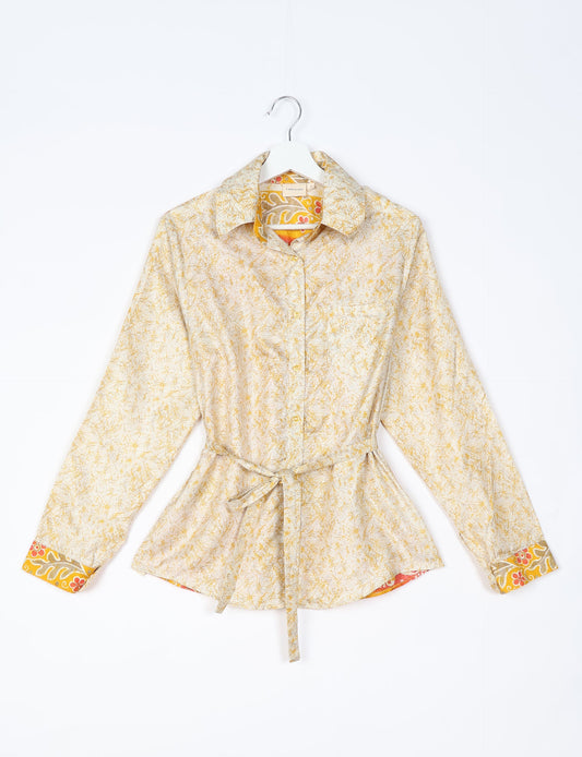 Experience sustainable fashion with our classic slim-fit shirt, crafted with ethical and green values. The shirt, designed for minimal waste, features a tie-up waist belt or neck tie, semi-spread collar, and regular shirt cuffs. Versatile and eco-friendly, wear it tucked in, unbuttoned over a tank top, or knotted at the waist for a unique style.