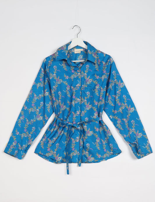 Experience sustainable fashion with our classic slim-fit shirt, crafted with ethical and green values. The shirt, designed for minimal waste, features a tie-up waist belt or neck tie, semi-spread collar, and regular shirt cuffs. Versatile and eco-friendly, wear it tucked in, unbuttoned over a tank top, or knotted at the waist for a unique style.