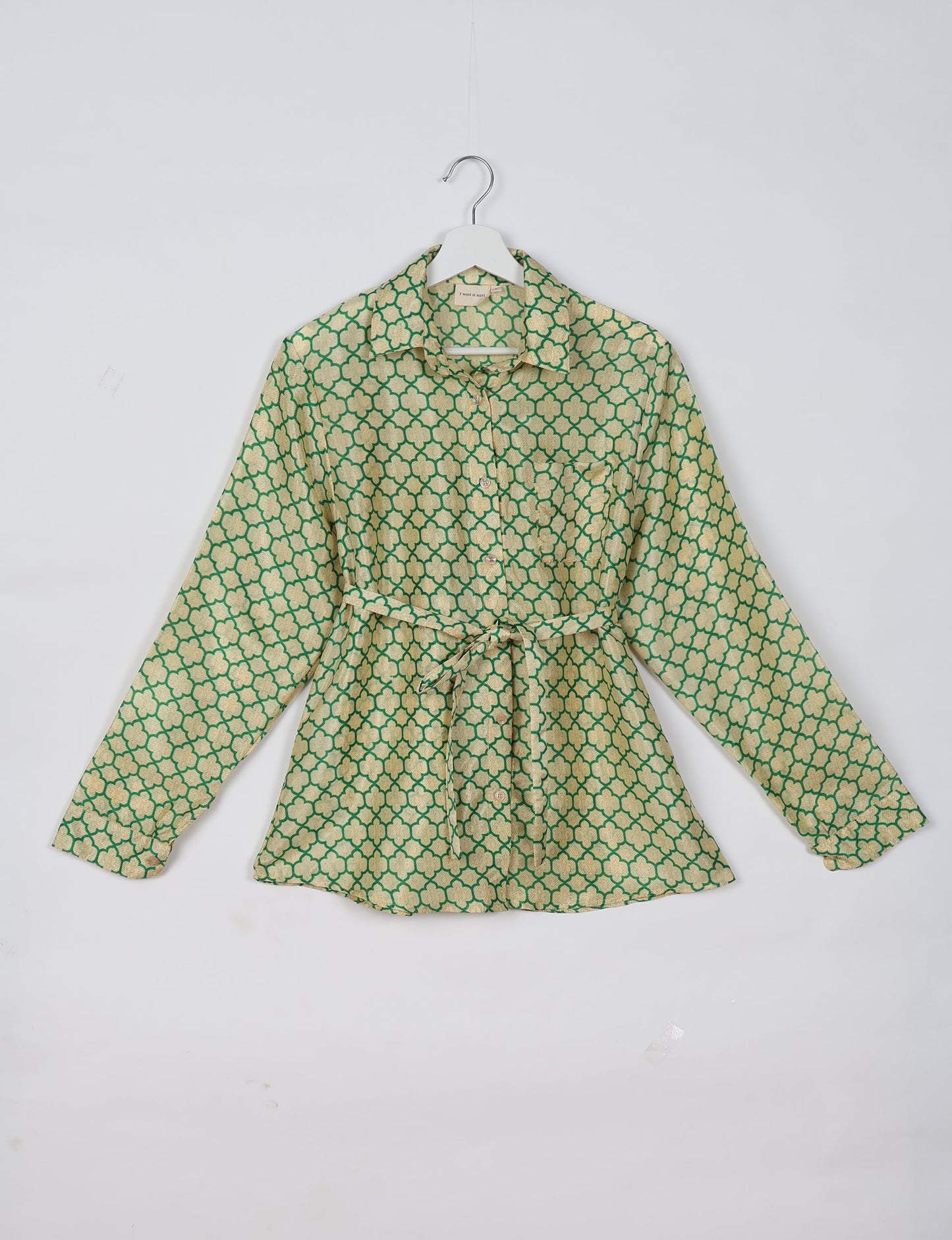 Experience sustainable fashion with our classic slim-fit shirt, crafted with ethical and green values. The shirt, designed for minimal waste, features a tie-up waist belt or neck tie, semi-spread collar, and regular shirt cuffs. Versatile and eco-friendly, wear it tucked in, unbuttoned over a tank top, or knotted at the waist for a unique style.