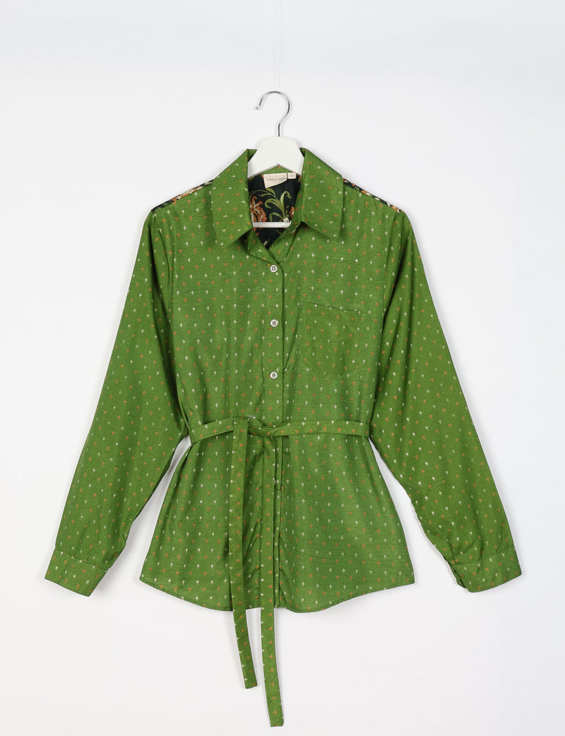 Green long-sleeve button-up shirt with small white and orange micro print, chest pocket, and waist tie belt, front view on