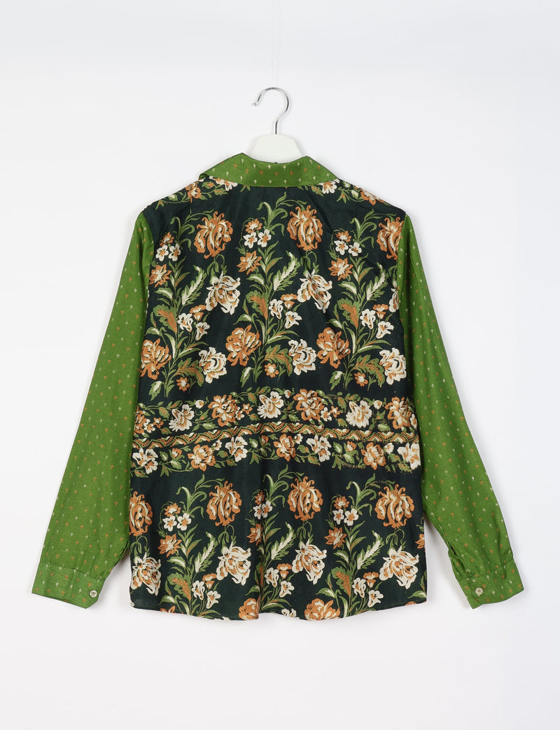Long-sleeve shirt with green sleeves and collar featuring small patterns, and a black back panel with orange and white