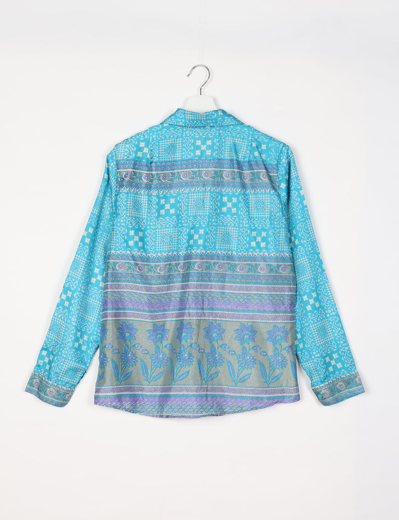 Blue Indian ethnic shirt with floral and geometric patterns, long sleeves, and buttoned cuffs, shown from back on hanger