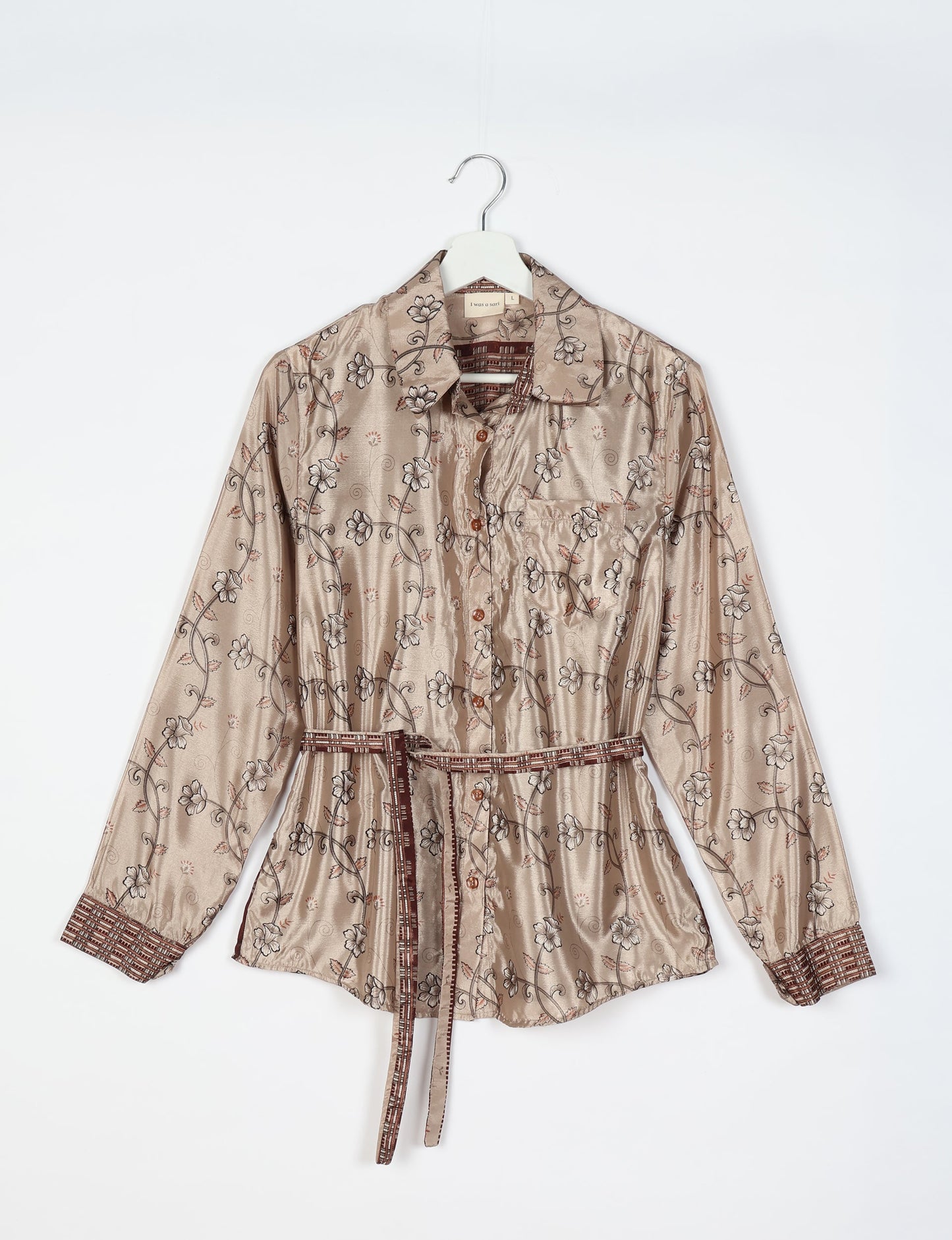 Experience sustainable fashion with our classic slim-fit shirt, crafted with ethical and green values. The shirt, designed for minimal waste, features a tie-up waist belt or neck tie, semi-spread collar, and regular shirt cuffs. Versatile and eco-friendly, wear it tucked in, unbuttoned over a tank top, or knotted at the waist for a unique style.