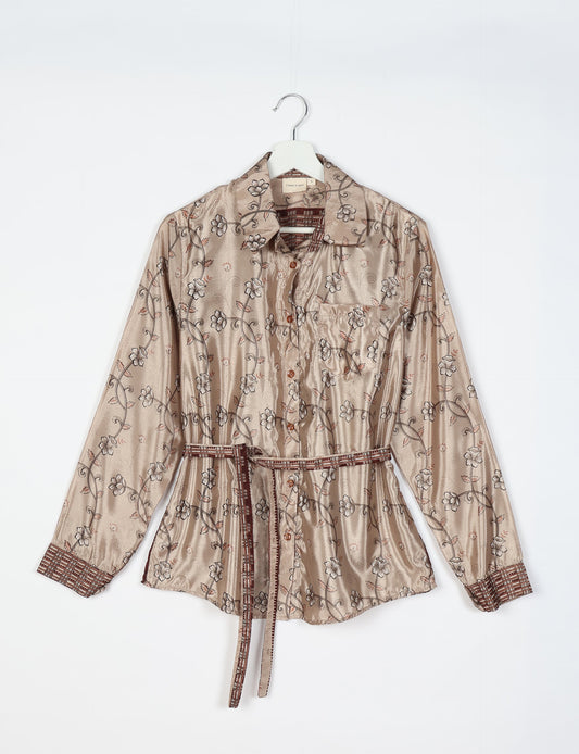 Experience sustainable fashion with our classic slim-fit shirt, crafted with ethical and green values. The shirt, designed for minimal waste, features a tie-up waist belt or neck tie, semi-spread collar, and regular shirt cuffs. Versatile and eco-friendly, wear it tucked in, unbuttoned over a tank top, or knotted at the waist for a unique style.