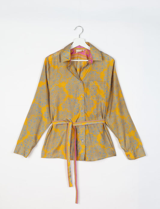 Experience sustainable fashion with our classic slim-fit shirt, crafted with ethical and green values. The shirt, designed for minimal waste, features a tie-up waist belt or neck tie, semi-spread collar, and regular shirt cuffs. Versatile and eco-friendly, wear it tucked in, unbuttoned over a tank top, or knotted at the waist for a unique style.