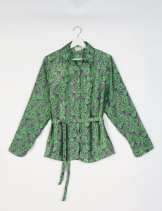 Experience sustainable fashion with our classic slim-fit shirt, crafted with ethical and green values. The shirt, designed for minimal waste, features a tie-up waist belt or neck tie, semi-spread collar, and regular shirt cuffs. Versatile and eco-friendly, wear it tucked in, unbuttoned over a tank top, or knotted at the waist for a unique style.