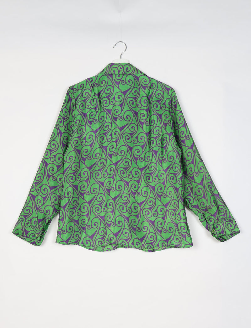 Green long-sleeve shirt with purple abstract swirl pattern, shown from back on a white hanger against white background
