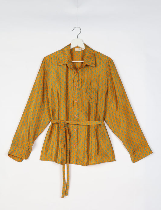 Experience sustainable fashion with our classic slim-fit shirt, crafted with ethical and green values. The shirt, designed for minimal waste, features a tie-up waist belt or neck tie, semi-spread collar, and regular shirt cuffs. Versatile and eco-friendly, wear it tucked in, unbuttoned over a tank top, or knotted at the waist for a unique style.