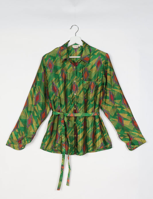 Experience sustainable fashion with our classic slim-fit shirt, crafted with ethical and green values. The shirt, designed for minimal waste, features a tie-up waist belt or neck tie, semi-spread collar, and regular shirt cuffs. Versatile and eco-friendly, wear it tucked in, unbuttoned over a tank top, or knotted at the waist for a unique style.