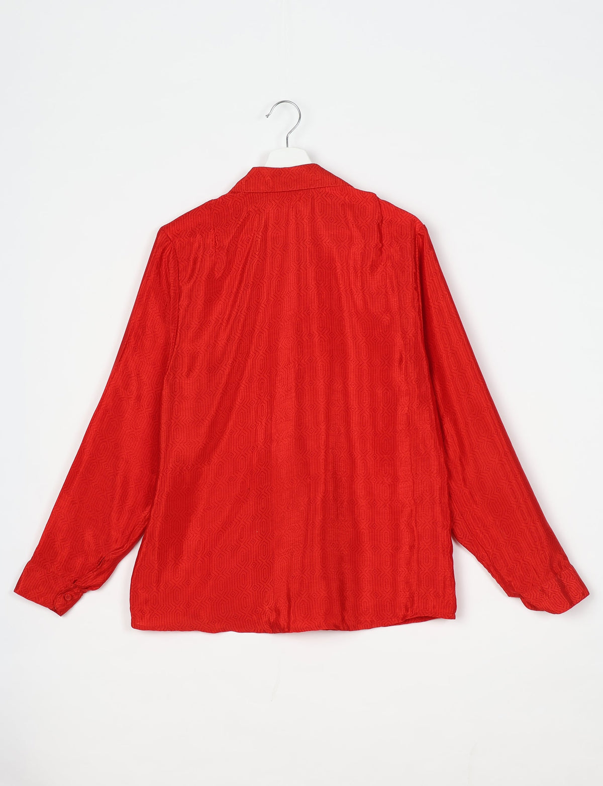 Red long-sleeve shirt with subtle geometric pattern, spread collar, and buttoned cuffs, shown from back on hanger