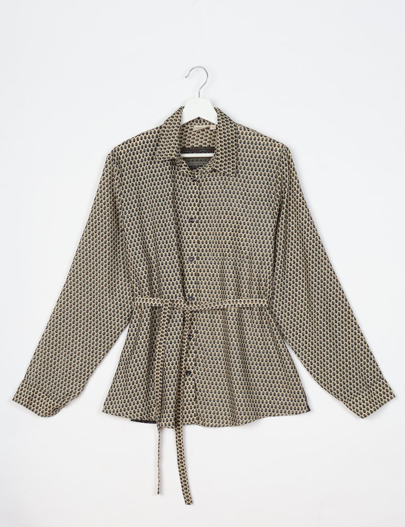 Beige long-sleeve button-up shirt with black micro floral pattern, collar, chest pocket, and waist tie, hanging on white hanger