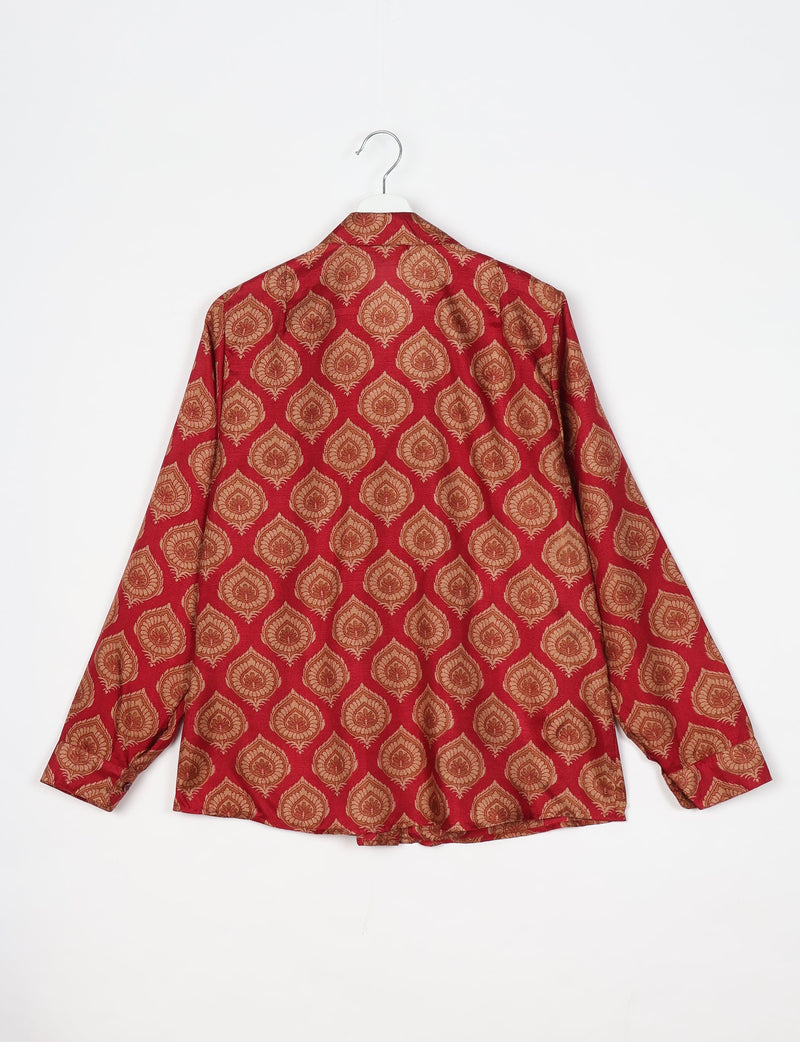 Red long-sleeve shirt with gold leaf pattern, shown from back, hanging on white hanger against white background