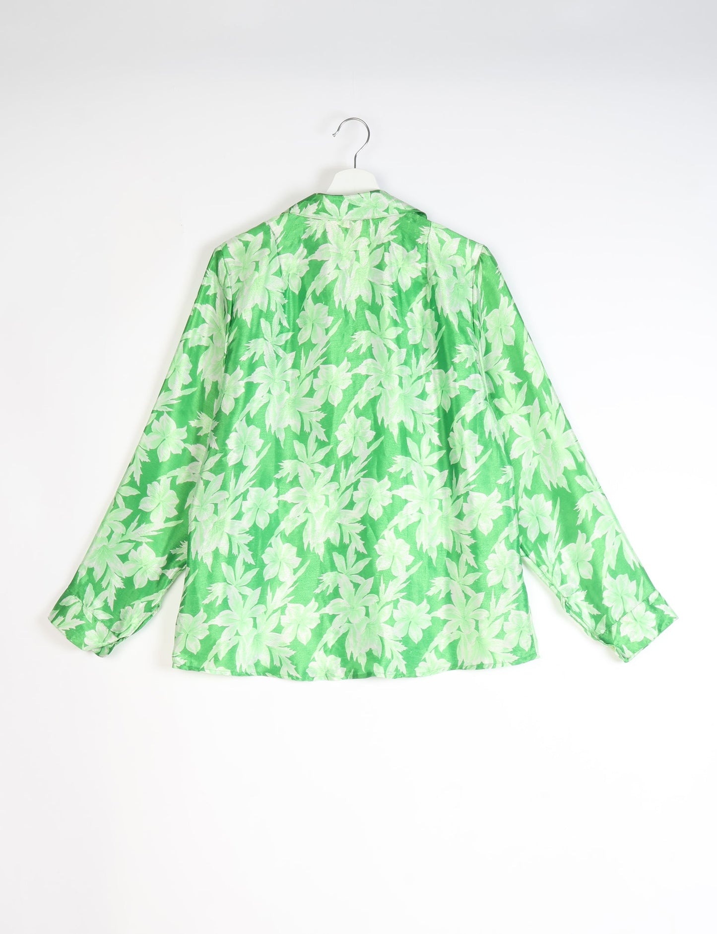 Green long-sleeve shirt with light green leaf pattern, shown from back on white hanger against white background