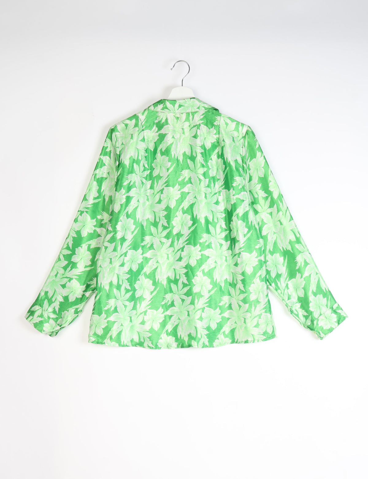 Green long-sleeve shirt with light green leaf pattern, shown from back on white hanger against white background