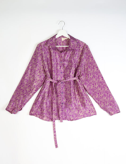 Experience sustainable fashion with our classic slim-fit shirt, crafted with ethical and green values. The shirt, designed for minimal waste, features a tie-up waist belt or neck tie, semi-spread collar, and regular shirt cuffs. Versatile and eco-friendly, wear it tucked in, unbuttoned over a tank top, or knotted at the waist for a unique style.