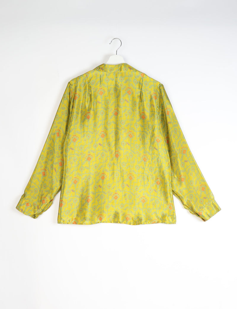 Yellow long-sleeve shirt with abstract geometric pattern in green and orange, shown from back on white hanger
