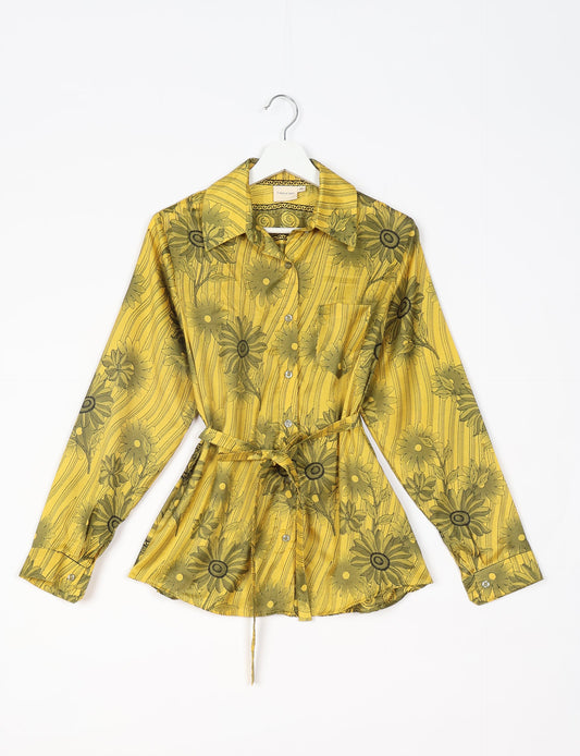 Experience sustainable fashion with our classic slim-fit shirt, crafted with ethical and green values. The shirt, designed for minimal waste, features a tie-up waist belt or neck tie, semi-spread collar, and regular shirt cuffs. Versatile and eco-friendly, wear it tucked in, unbuttoned over a tank top, or knotted at the waist for a unique style.