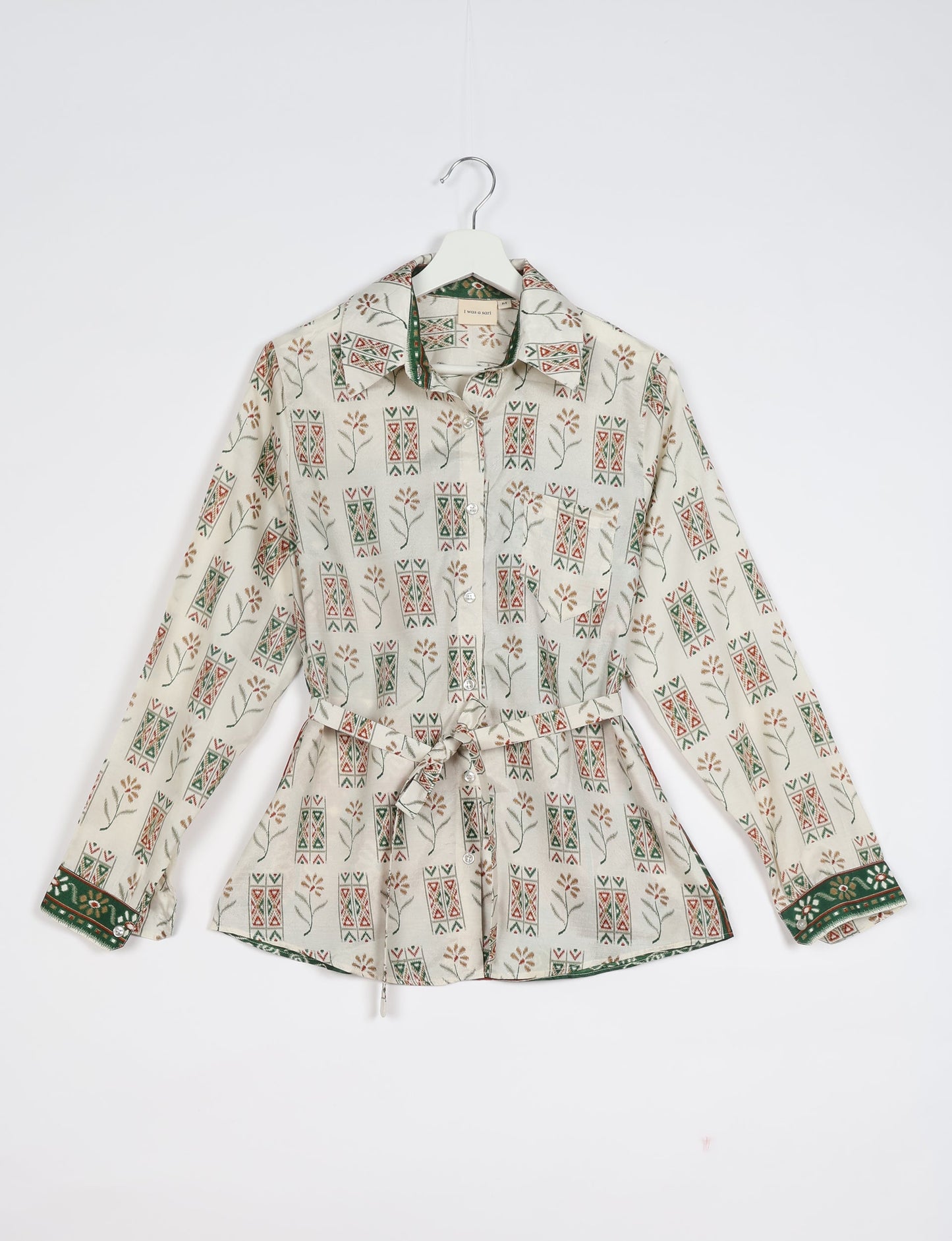 Experience sustainable fashion with our classic slim-fit shirt, crafted with ethical and green values. The shirt, designed for minimal waste, features a tie-up waist belt or neck tie, semi-spread collar, and regular shirt cuffs. Versatile and eco-friendly, wear it tucked in, unbuttoned over a tank top, or knotted at the waist for a unique style.