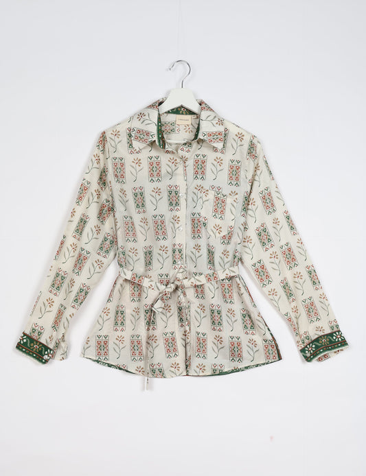 Experience sustainable fashion with our classic slim-fit shirt, crafted with ethical and green values. The shirt, designed for minimal waste, features a tie-up waist belt or neck tie, semi-spread collar, and regular shirt cuffs. Versatile and eco-friendly, wear it tucked in, unbuttoned over a tank top, or knotted at the waist for a unique style.