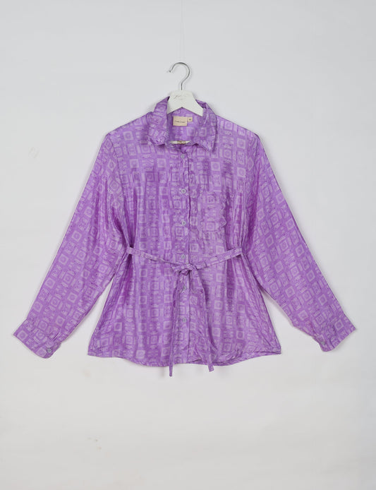 Experience sustainable fashion with our classic slim-fit shirt, crafted with ethical and green values. The shirt, designed for minimal waste, features a tie-up waist belt or neck tie, semi-spread collar, and regular shirt cuffs. Versatile and eco-friendly, wear it tucked in, unbuttoned over a tank top, or knotted at the waist for a unique style.