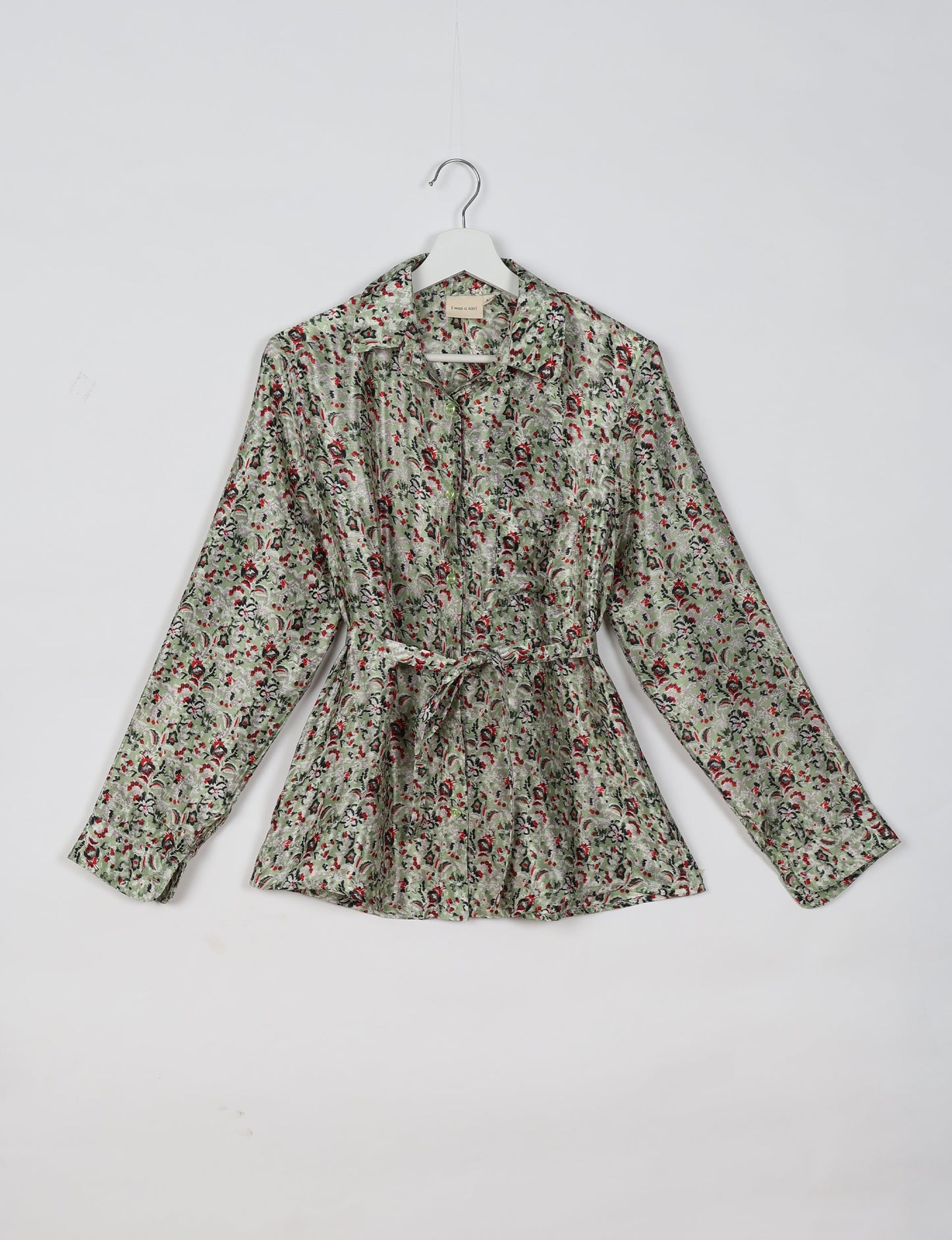 Experience sustainable fashion with our classic slim-fit shirt, crafted with ethical and green values. The shirt, designed for minimal waste, features a tie-up waist belt or neck tie, semi-spread collar, and regular shirt cuffs. Versatile and eco-friendly, wear it tucked in, unbuttoned over a tank top, or knotted at the waist for a unique style.