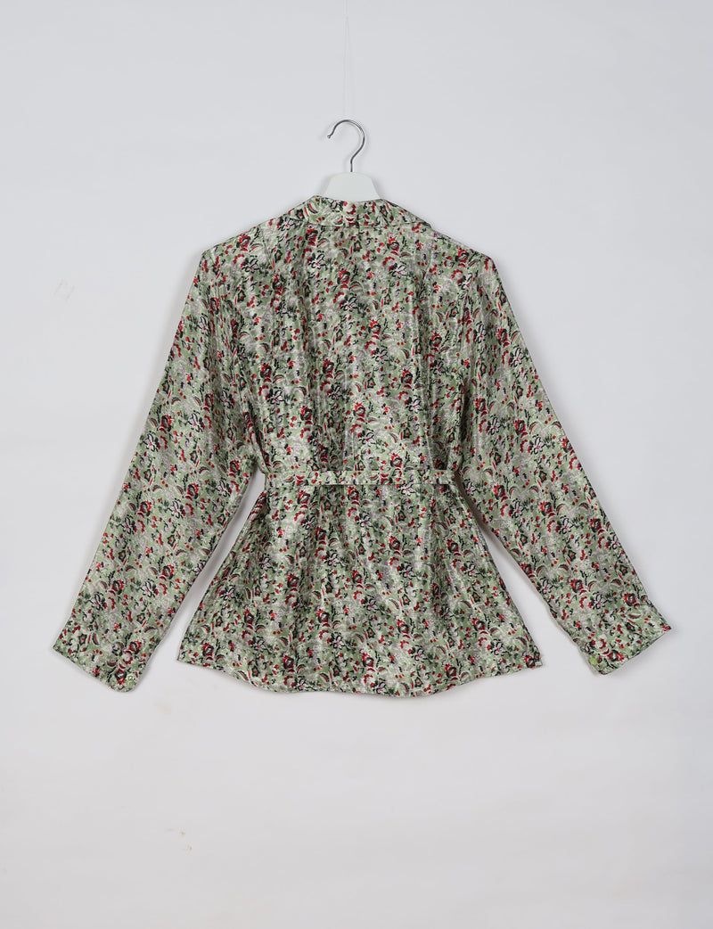 Beige tropical print long-sleeve shirt with belt detail, shown from back on white hanger against white background